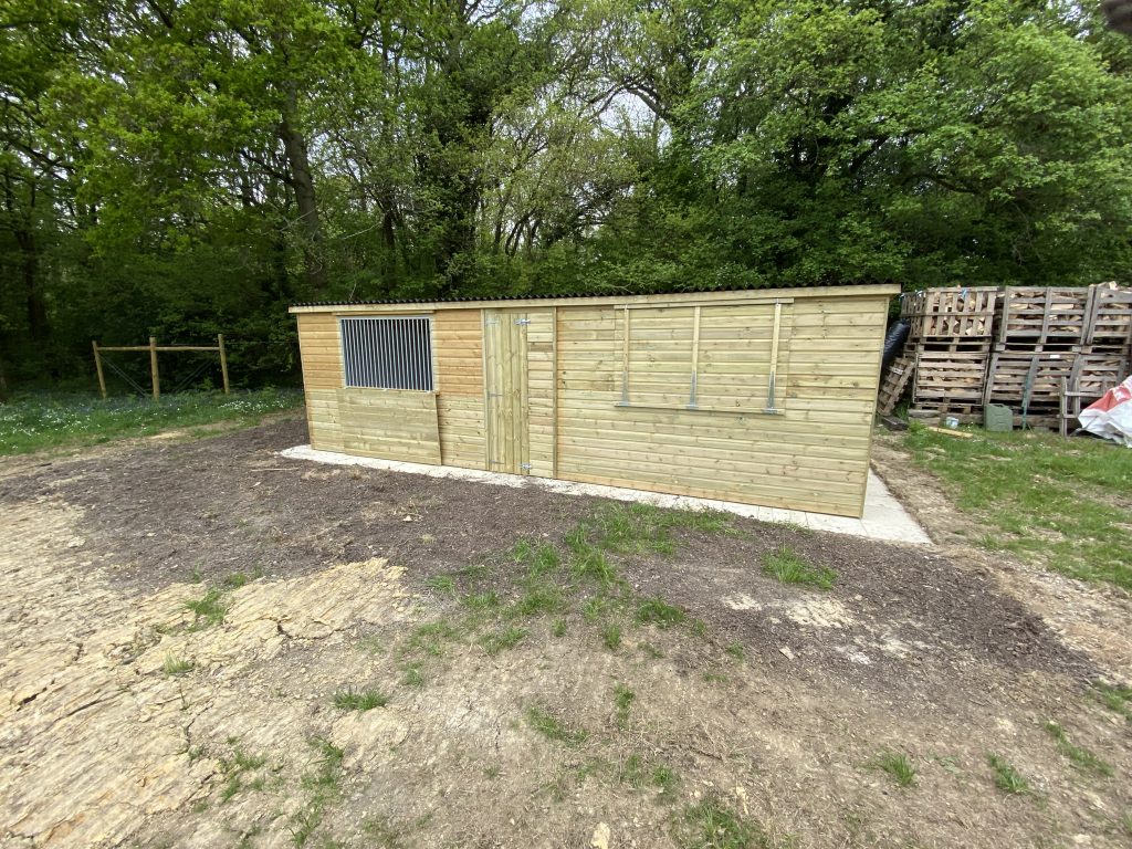 Wooden barn owl aviary with sheltered mews and mesh flight